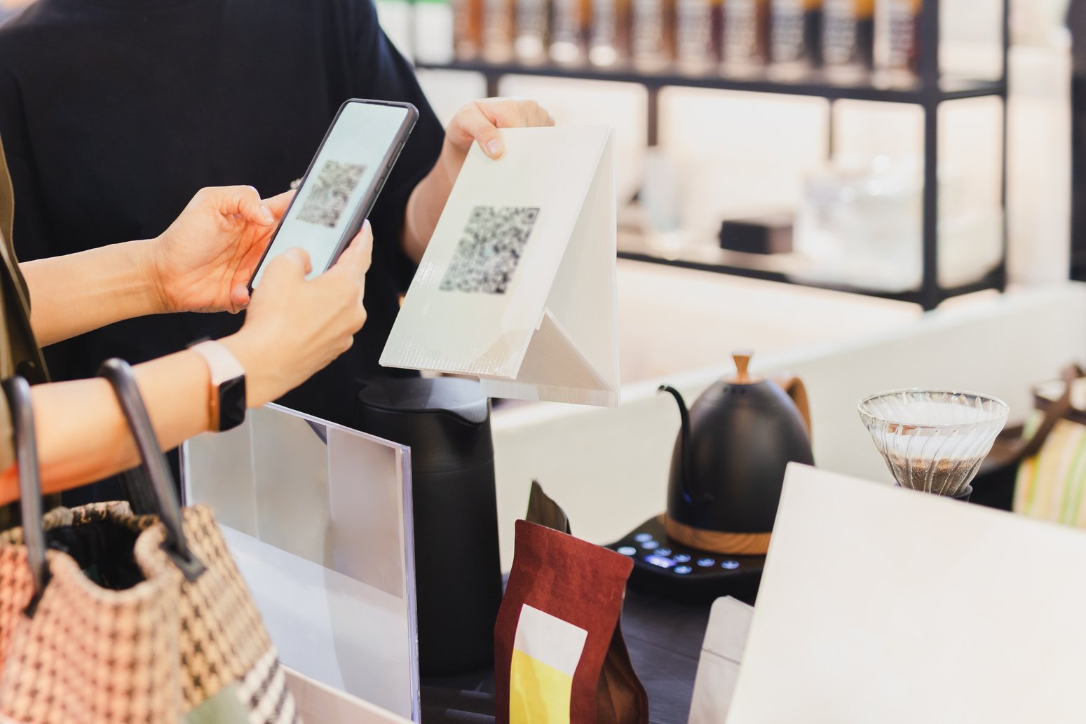 Women customer paying by QR code scanning on mobile phone at sho